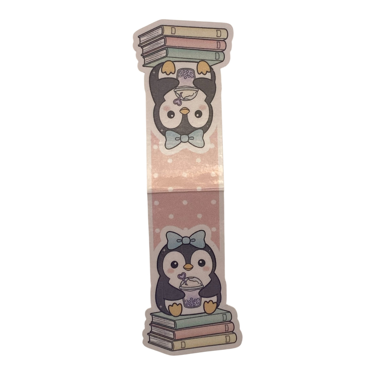 A die-cut sticker featuring a cute cartoon penguin holding books, shown on a plain white background.