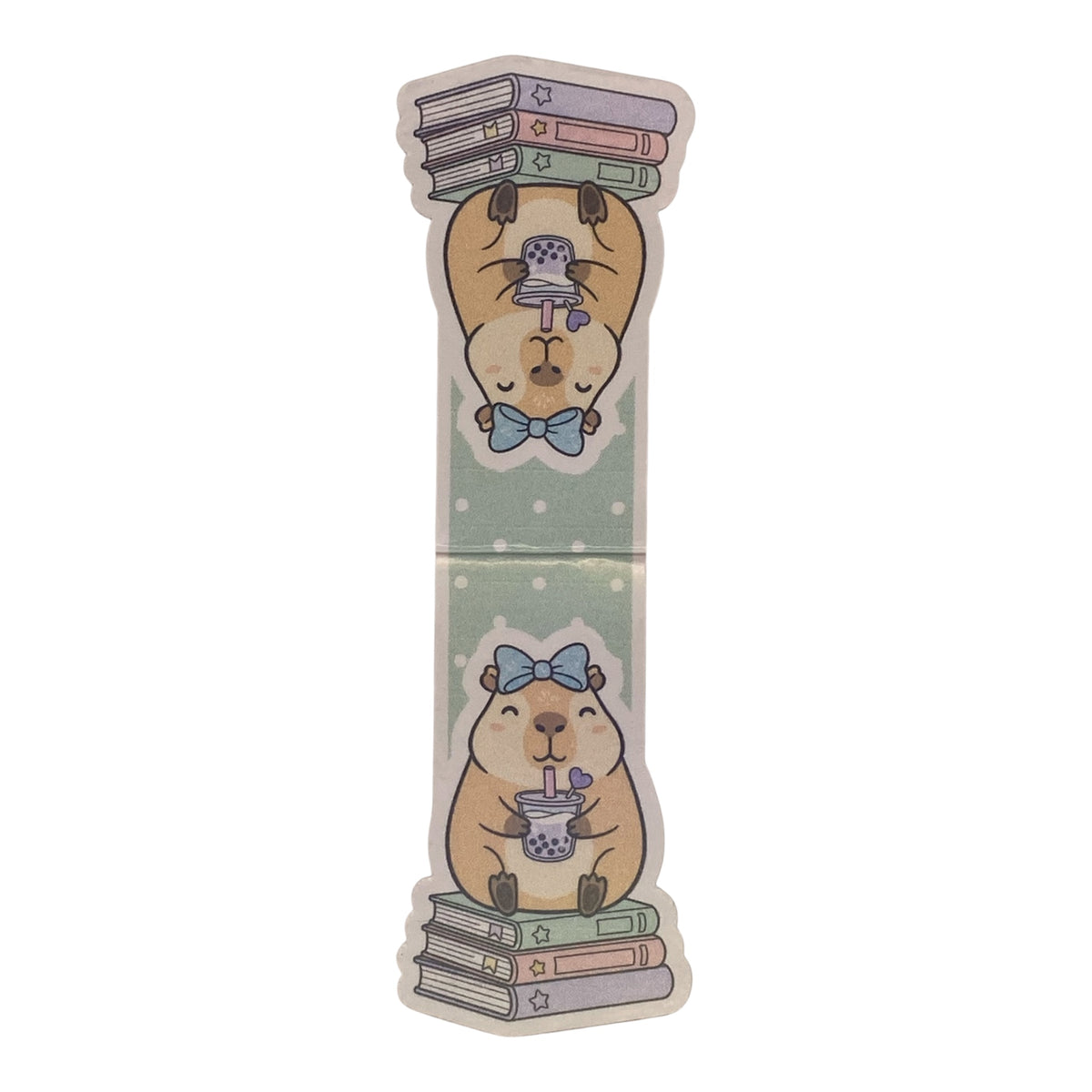 A die-cut sticker featuring a cute cartoon guinea pig illustration. The design shows a beige guinea pig with a blue bow tie, one version holding a stack of books on its head and the other holding a cup of boba tea, set against a light green dotted background.