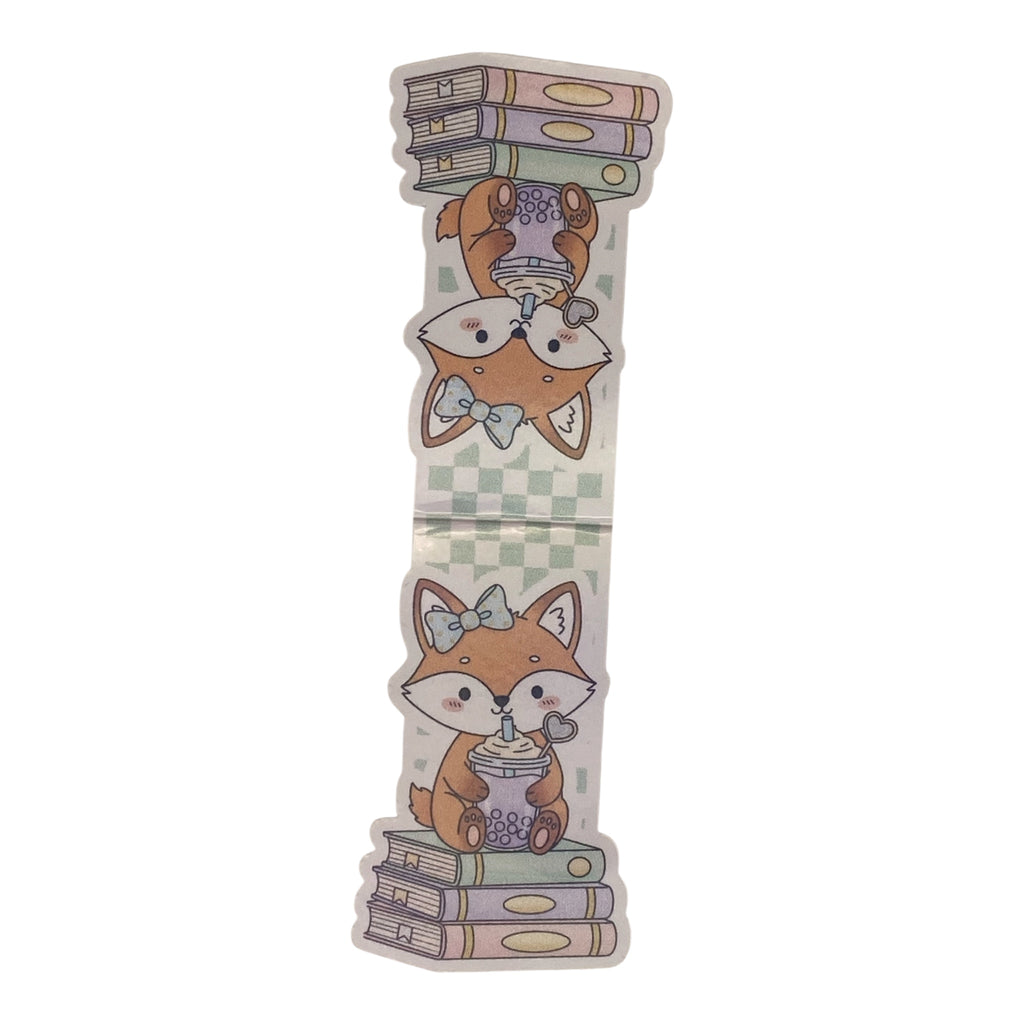 A single die-cut magnetic bookmark featuring a cute cartoon fox illustration with books and a cup, shown on a plain white background.
