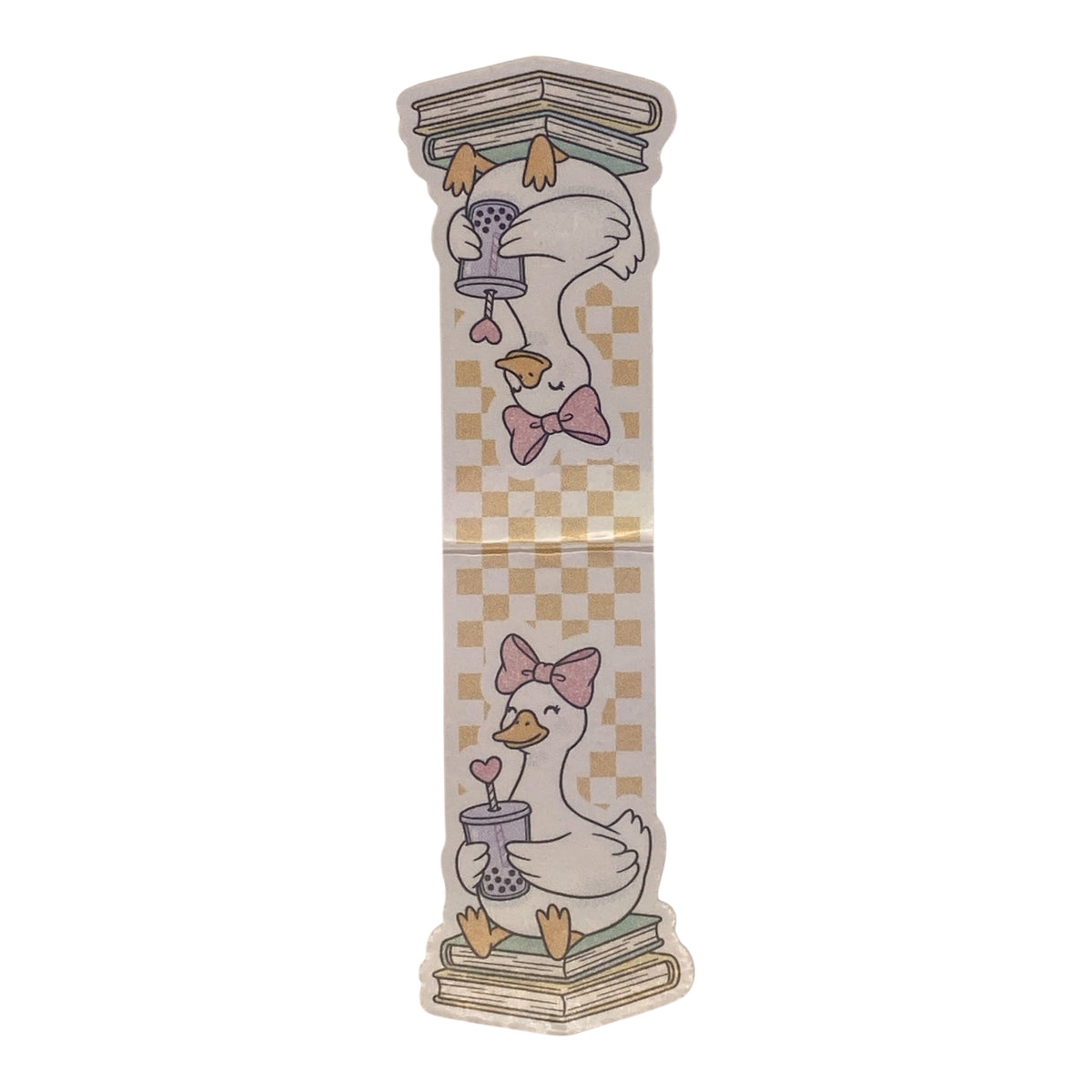 A magnetic bookmark featuring a whimsical illustration of a white goose wearing a pink bow, perched on books and holding a small vase with a heart-shaped flower, set against a beige and yellow checkerboard background.
