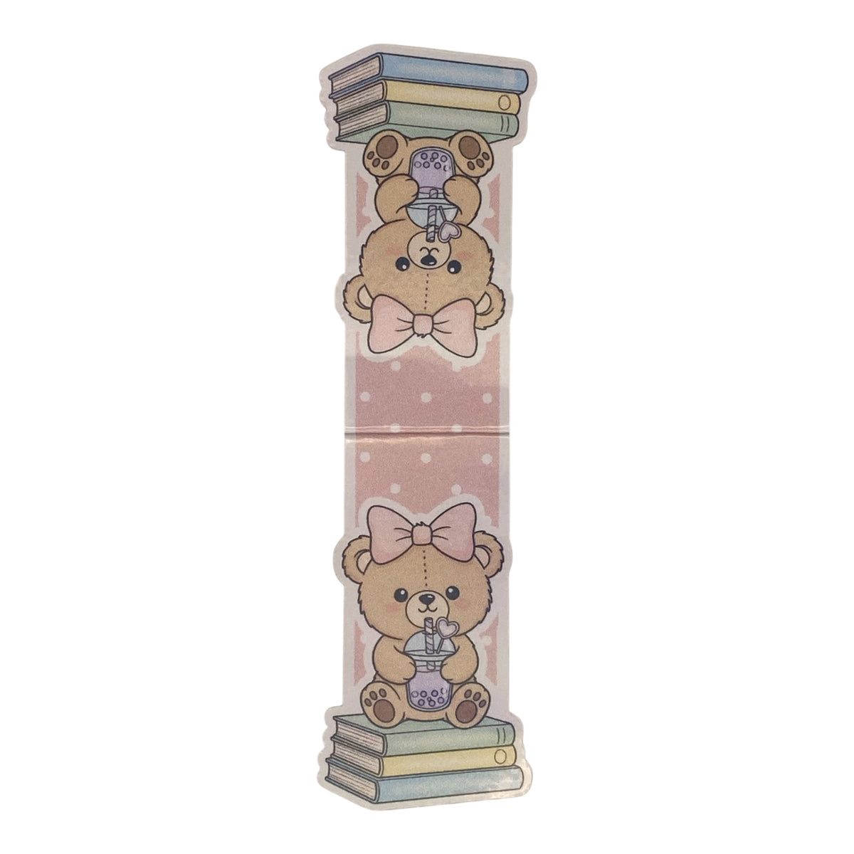 A tall, narrow decorative magnetic bookmark featuring two cute teddy bear illustrations on a pale pink background with white dots. The top bear wears a pink bow and holds a purple teapot balanced on stacked books, while the bottom bear wears a large pink bow and holds a purple teapot balanced on stacked books.