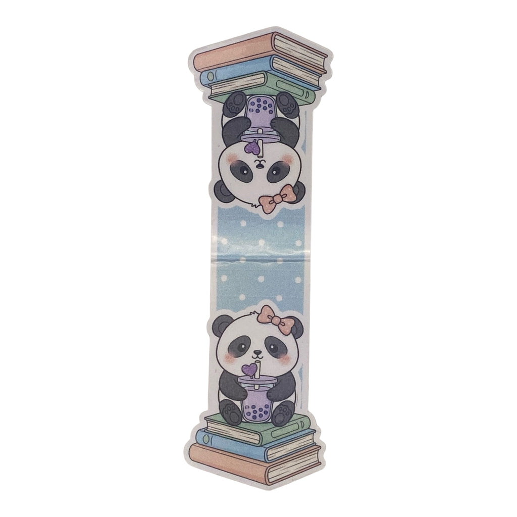 A magnetic bookmark featuring a cute cartoon panda sitting on stacked books with  a purple bubble tea cup, mirrored with a second panda upside down at the top, shown on a plain white background.
