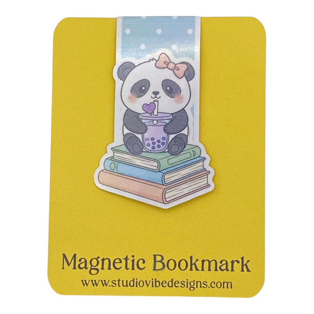 A yellow magnetic bookmark card featuring a cute cartoon panda sitting on stacked books and holding a purple drink, with the text 'Magnetic Bookmark' and 'www.studiovidesigns.