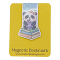 A yellow magnetic bookmark card featuring a cute cartoon panda sitting on stacked books and holding a purple drink, with the text 'Magnetic Bookmark' and 'www.studiovidesigns.