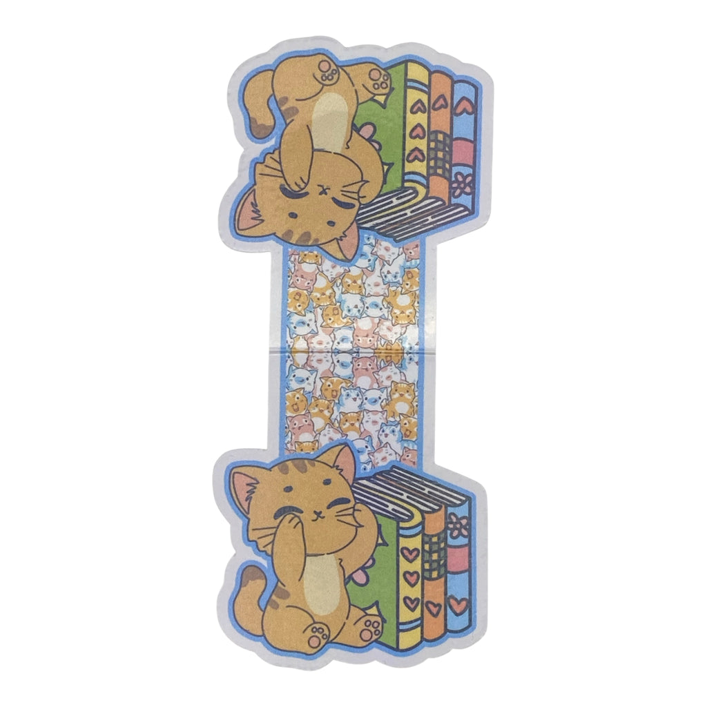 A magnetic bookmark featuring a cute orange tabby cat illustration with books on either side, shown on a plain white background.