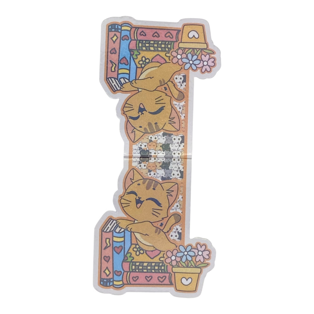 A cute magnetic bookmark featuring a cute cartoon design with two orange tabby cats, books, flowers, and a small potted plant on a white background.