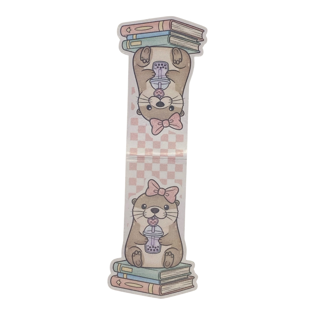 A die-cut magnetic bookmark featuring a cute cartoon otter illustration. The otter is shown upside down holding a stack of books on its paws and sitting on a stack of books below, holding a purple bubble tea cup.