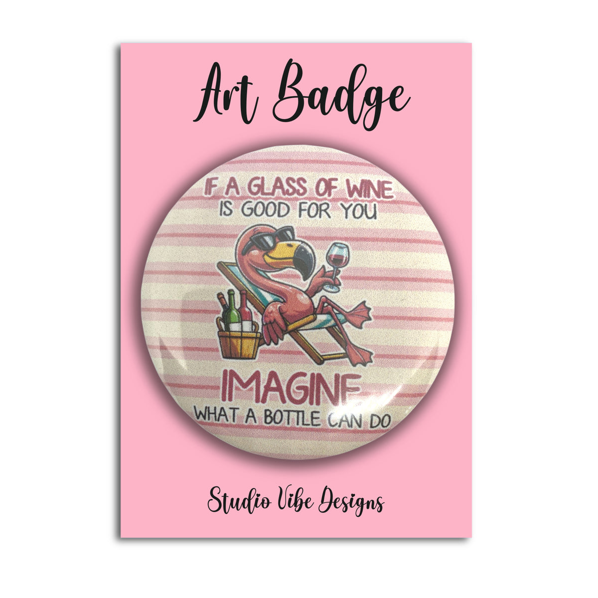 A round pin badge featuring a cartoon flamingo relaxing in a chair with a wine glass, displayed on a pink backing card that reads 'Art Badge' and 'Studio Vibe Designs'.