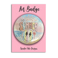 A round art badge featuring retro summer-themed artwork with the words 'Hello SUMMER' and a smiley face, displayed on a pink backing card labeled 'Art Badge' and 'Studio Vibe Designs'.